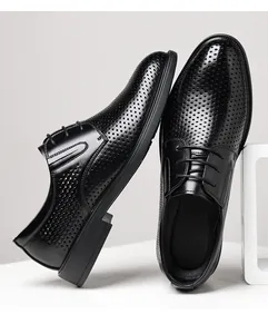 Close-up detail of black men's perforated leather dress shoes for summer business.