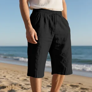 Close-up of black linen beach shorts featuring a drawstring waist and breathable texture