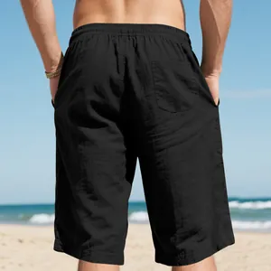 Back view of men's black linen beach shorts featuring an elastic waist and pocket.