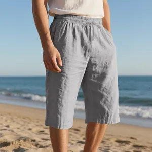 Men's breathable linen shorts with drawstring waist shown in a sunny beach setting.