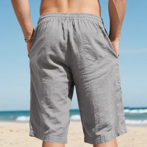 Detail of men's grey linen beach shorts featuring elastic waist and back pocket design