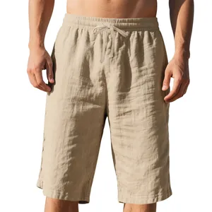 Detail of beige linen drawstring shorts with elastic waist for men's casual beach wear.