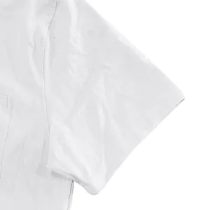Detailed close-up of white linen short sleeve shirt fabric and pocket stitching