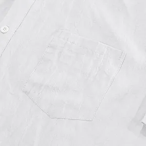 Close-up macro view of men's white linen shirt pocket showing textured breathable summer fabric