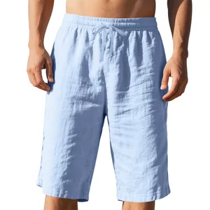 Front view detail of men's light blue linen beach shorts with drawstring elastic waist