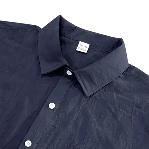 Close-up of a men's navy blue linen blend short-sleeve shirt collar showing size tag