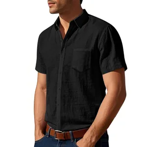 Detailed close-up view of a black short-sleeved linen shirt featuring chest pocket and lapel