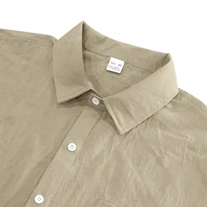 Detail view of khaki linen short sleeve shirt collar and fabric texture with neck label