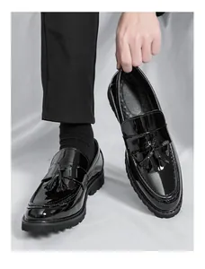 Primer plano de los mocasines de charol negro para hombre con textura brillante