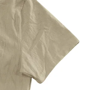 Close-up of khaki linen shirt sleeve showing detailed stitching and fabric texture