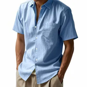 Detailed view of a men's light blue linen shirt featuring a breast pocket and classic collar.