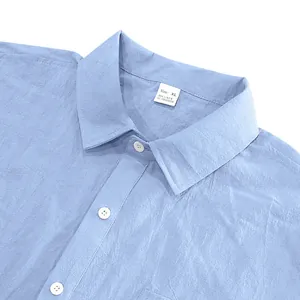 Close-up of blue linen shirt collar and tag showing 95% linen material and XL size.