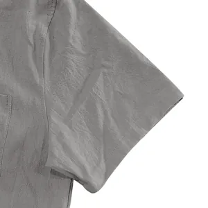 Close-up detail of grey linen short sleeve shirt showing premium fabric texture and seams