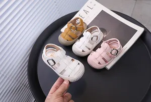 Detailed view of colorful baby walking sandals with soft soles and closed-toe protection