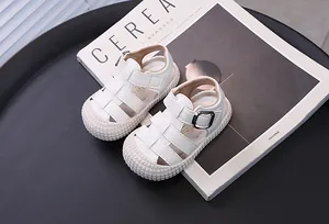 Close-up of white baby closed-toe walking sandals with soft anti-slip rubber soles