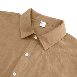Close-up of the collar and size label on a brown men's short-sleeve linen shirt.