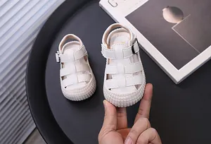 Close-up of white infant soft sole walking sandals with anti-kick closed-toe design