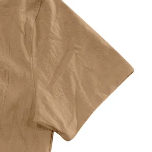 Detailed close-up of khaki short-sleeve linen shirt showing premium slub fabric texture