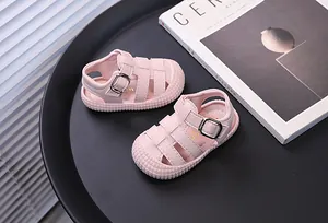 Detailed shot of pink baby sandals with anti-kick closed toe and soft sole