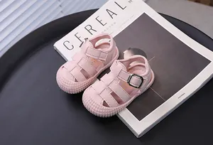 Detail of pink toddler sandals with soft sole and anti-collision closed toe design.