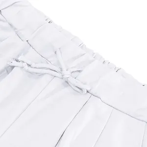 Close-up detail of white sports shorts featuring an elastic waistband and drawstring
