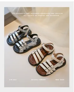 Close-up view showing details of stylish girls' Roman sandals in silver and white