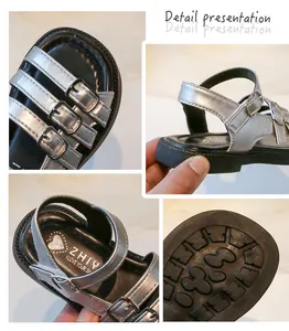 Detail views of silver girls' Roman sandals showing the buckles and non-slip sole texture