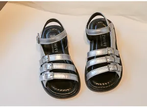 Detailed top-down view of silver girls' Roman sandals with stylish buckle straps