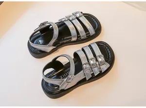 Detailed view of silver girls' Roman sandals with triple buckle straps