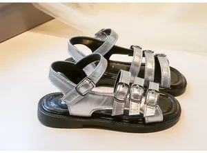 Stylish silver metallic girls Roman sandals featuring multiple buckle straps and durable black soles