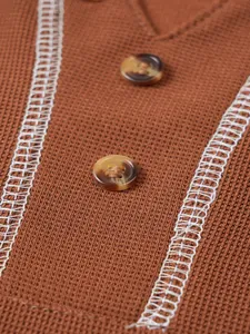 Close-up of brown Henley shirt showing knit texture, buttons and white contrast stitching.