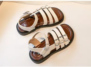 Detail view of white girls Roman sandals with adjustable buckle straps and brown footbed