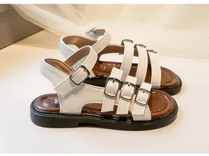 Detailed side view of white girl's Roman sandals with stylish multi-buckle design