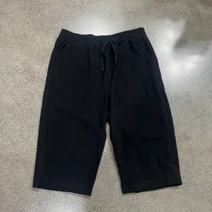 Men's loose black linen casual cropped pants featuring a comfortable drawstring waist