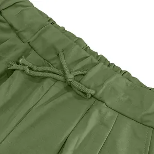 Detailed macro view of the olive green elastic waistband and drawstring on men's sports shorts