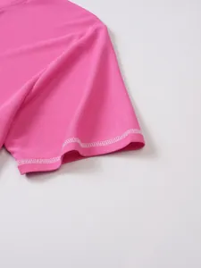 Close-up of pink Henley shirt sleeve showing waffle knit texture and white stitching details
