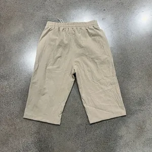 Detailed back view of men's beige linen casual shorts featuring elastic waist and pocket