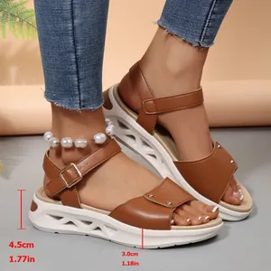 Dettaglio di sandali con zeppa marroni con tacco di 4,5 cm e suola platform bianca