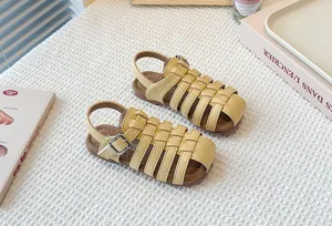 Detailed view of yellow hollow-out woven children's Roman sandals with soft soles