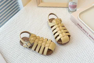 Detail view of beige woven children's Roman sandals with closed-toe design