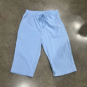 Overview of light blue men's casual linen cropped pants showing drawstring waist and texture