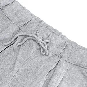 Close-up detail of grey high street sports shorts with elastic waistband and drawstring