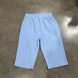 Detailed back view of men's light blue loose linen 7-point casual beach shorts for summer