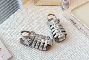 Detailed view of silver woven Roman sandals for girls with comfortable soft soles.