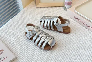 Detailed view of elegant silver woven Roman sandals for children featuring soft flexible soles