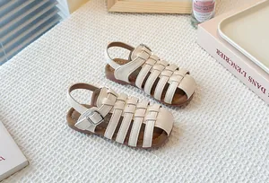 Detail view of cream woven cutout Roman sandals for kids with soft soles for beach