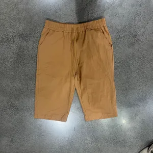 Flat lay view of men's brown linen casual 7-point shorts with drawstring waist.