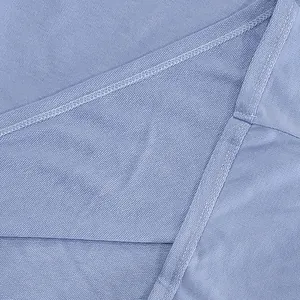 Close-up of heavy French terry fabric texture and fine stitching on blue sportswear