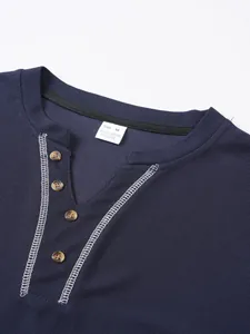 Close-up detail showing the navy waffle knit Henley shirt neckline with buttons and tag