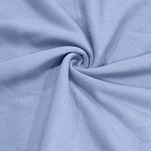 Detailed macro shot of heavyweight light blue terry knit fabric for streetwear sets.
